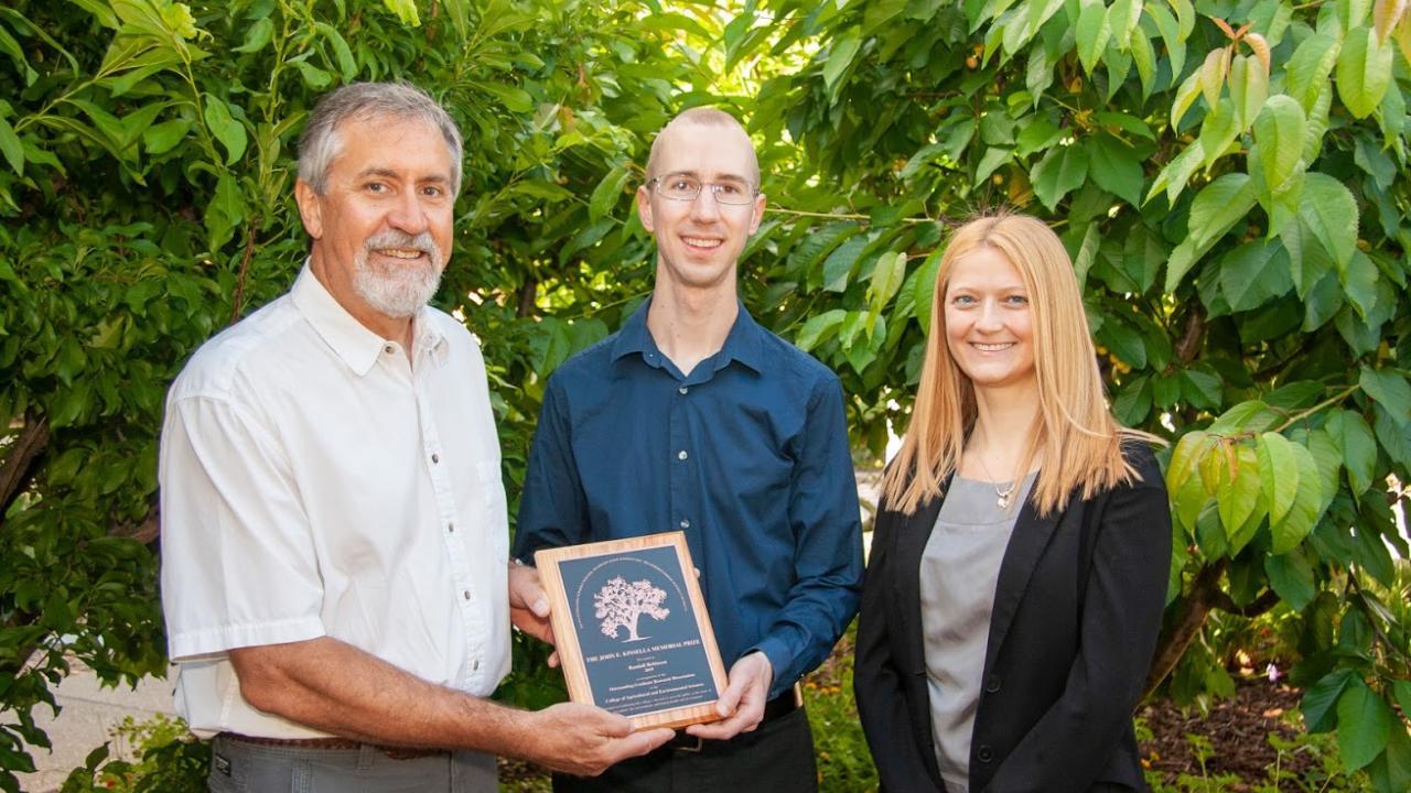 Ron Tjeerdema presents the 2019 Kinsella Memorial Prize to Randall Robinson along with Associate Professor Daniela Barile. Randall Robinson